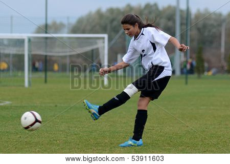 KAPOSVAR, HUNGARY - NOVEMBER 3: Dorisz Druzsin (in white) in action at Hungarian Championship under 15 women soccer game Rakoczi FC (white) vs Pecsi MFC (red) November 3, 2013 in Kaposvar, Hungary.
