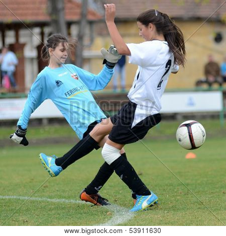 KAPOSVAR, HUNGARY - NOVEMBER 3: Dorisz Druzsin (in white) in action at  a Hungarian Championship under 15 women soccer game Rakoczi FC (white) vs Pecsi MFC (red) November 3, 2013 in Kaposvar, Hungary.