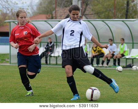 KAPOSVAR, HUNGARY - NOVEMBER 3: Dorisz Druzsin (in white) in action at  a Hungarian Championship under 15 women soccer game Rakoczi FC (white) vs Pecsi MFC (red) November 3, 2013 in Kaposvar, Hungary.