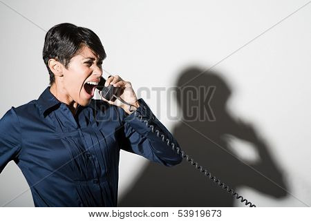 Businesswoman shouting on telephone