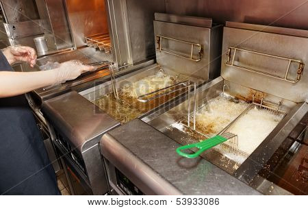 Deep fryer with boiling oil on restaurant kitchen 