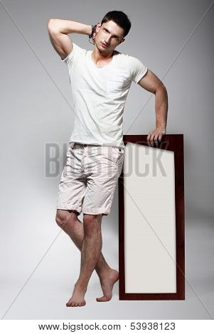Elegant Young Man In White Cotton Clothes With Board Standing
