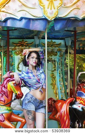 Merry-go-round. Playful Stylish Showy Woman In Roundabout. Funfair