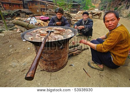 Asians Are Sitting On Road Near Meals With Boiled Meat.