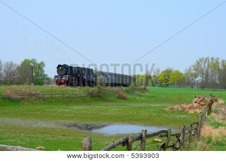 Venkovské krajiny s parním vlakem