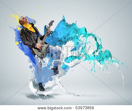 Young man, rock musician in jacket playing guitar