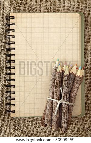 Bunch of wooden color pencils and on brown background