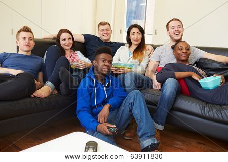 Group Of Friends Watching Television At Home Together