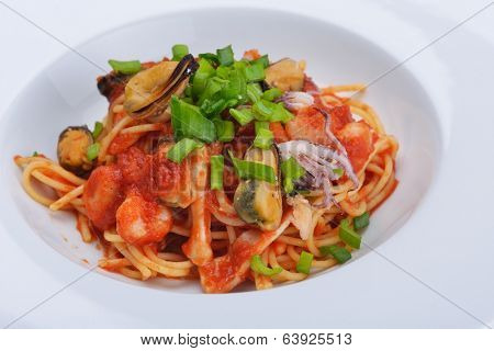 Pasta with shrimps, herbs and mashrooms isolated on white background in studio