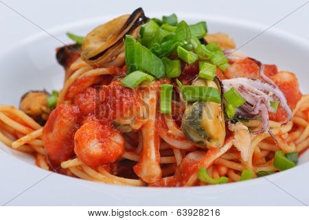 Pasta with shrimps, herbs and mashrooms isolated on white background in studio