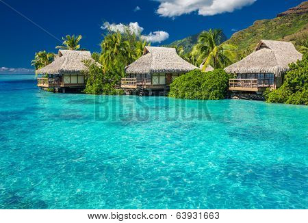 Overwater villas in tropical lagoon of Moorea Island