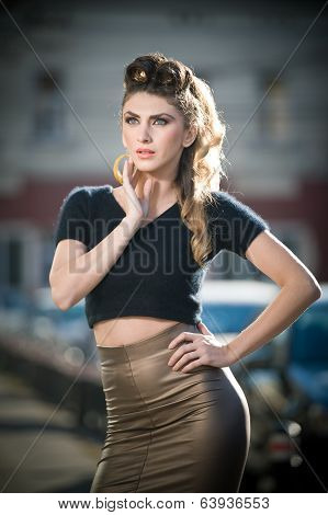 Attractive young woman in a urban fashion shot. Beautiful fashionable young girl with tight skirt