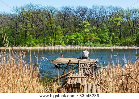 Man on summer lake