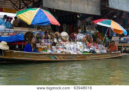 RATCHABURI, THAILAND - MARCH 24: Local peoples sell fruits, food and souvenirs at famous tourist attraction Damnoen Saduak floating market on March 24, 2014 in Ratchaburi, Thailand.