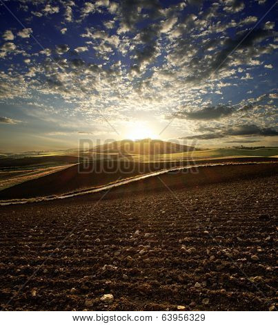 sunset on plowed land