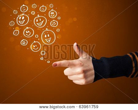 Group of happy hand drawed smiley faces coming out of gun shaped hands
