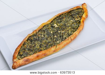 Homemade traditional Turkish meal pide stuffed with meat cheese,  and sauce isolated on white background