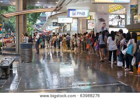 SINGAPORE - NOVEMBER 09, 2012: People queue for a taxi street Orchard Road in Singapore.Orchard Road - this 2.2 km street is the retail and entertainment hubs of Singapore and major tourist attraction