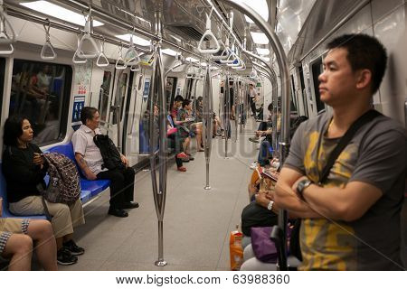 SINGAPORE - AUGUST 15: Passengers in the train subway Singapore. Singapore's subway , also known as MRT, started operating in 1987. It's network length is 130 kms, it has 87 stations and 4 lines.