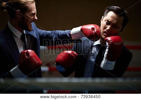 Gloating businessman fighting with rival