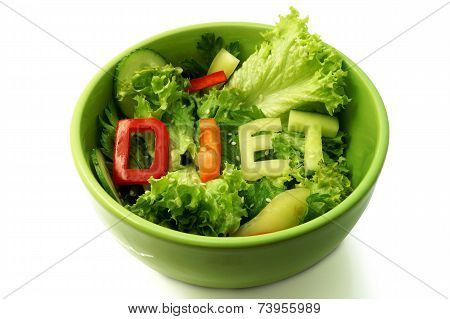 Green plate with word diet composed of slices of different vegetables on salad