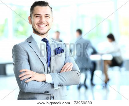 successful businessman with colleagues in the background