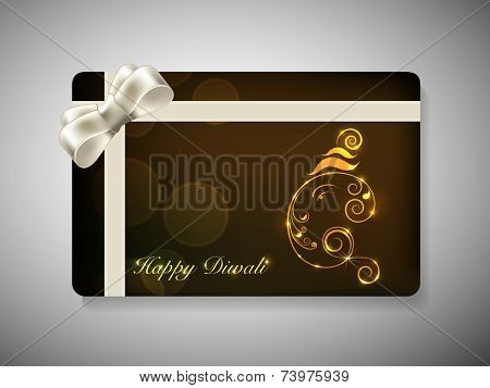 Happy Diwali gift card with Lord Ganesha made by floral design and silver ribbon decoration on brown background. 
