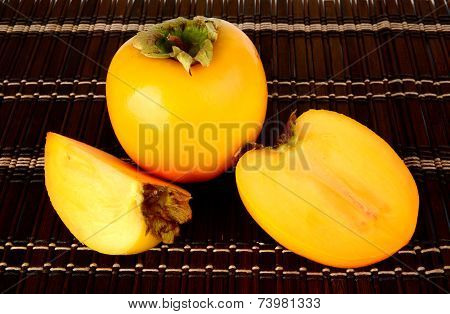 Studio Shot Of Sliced Kakis On Mat