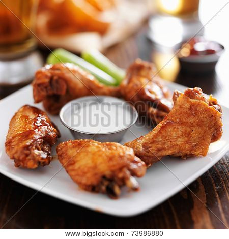 buffalo barbecue hot chicken wings around ranch sauce with celery