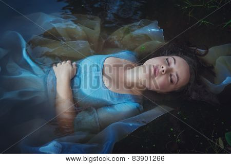 Young Beautiful Drowned Woman In Blue Dress Lying In The River