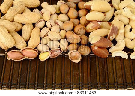 Close Up Shot Of Many Nuts From Above On Brown Mat