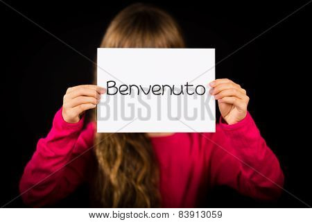 Child Holding Sign With Italian Word Benvenuto - Welcome