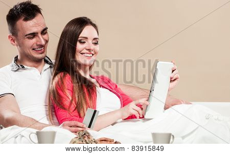 Young Couple With Tablet And Credit Card At Home