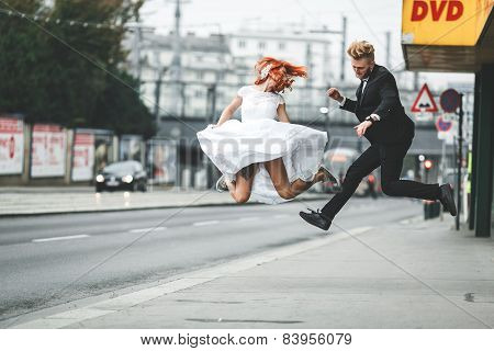 Wedding Couple Jumping In The City