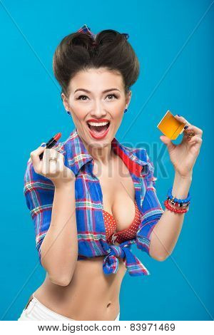 Sexy young pin-up girl doing make-up