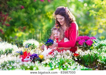 Mother And Daughter Planting Flowers