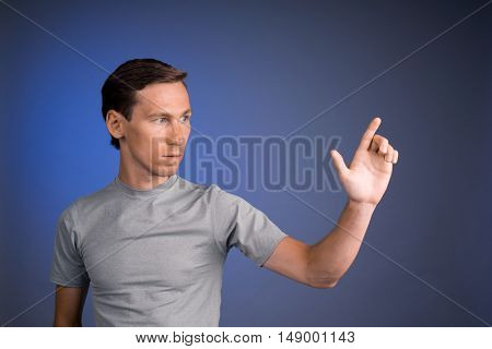 Man working with virtual touch screen.