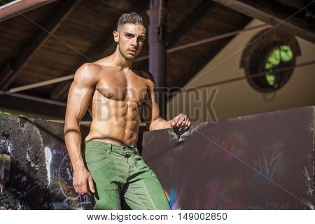 Handsome Muscular Shirtless Hunk Man Outdoor in City Setting. Showing Healthy Body While Looking away