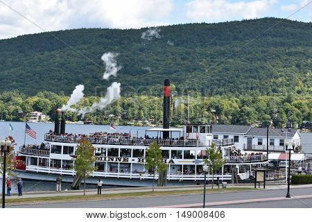 LAKE GEORGE, NY - SEP 24: Cruises around Lake George in New York State, as seen on Sep 24, 2016. The lake lies within the upper region of the Great Appalachian Valley and drains all the way northward into Lake Champlain and the St. Lawrence River drainage