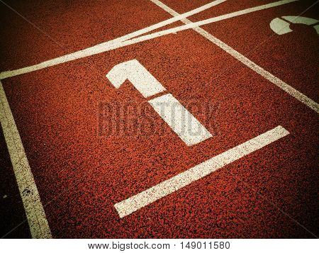 Number One. White Track Number On Red Rubber Racetrack