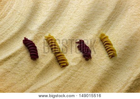 some color pasta on the yellow flour