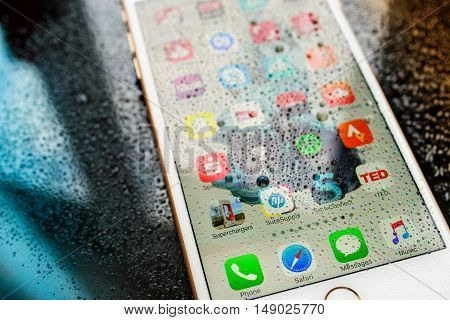 PARIS FRANCE - SEP 26 2016: New Apple iPhone 7 Plus unboxing and testing - home screen with apps under rain . New iPhone7 is one of the best waterproof smart phone in the world