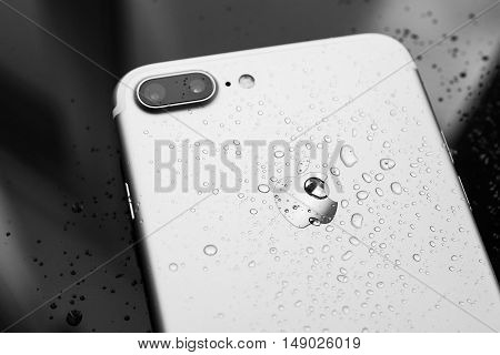 PARIS FRANCE - SEP 26 2016: New Apple iPhone 7 Plus unboxing and testing - water drops on rear - studio shot. New iPhone7 is one of the best waterproof smart phone in the world