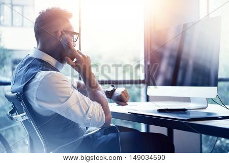 Bearded Businessman Wearing White Shirt Waistcoat Working Modern Loft Startup Computer.Creative Young Man Using Mobile Phone Call Partner Meeting.Gentleman Guy Looking Watch Workplace.Blurred Flares