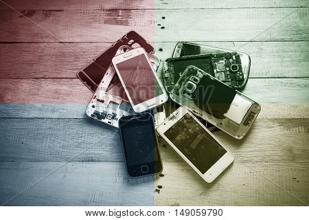 Broken smart phone with space in wooden texture background
