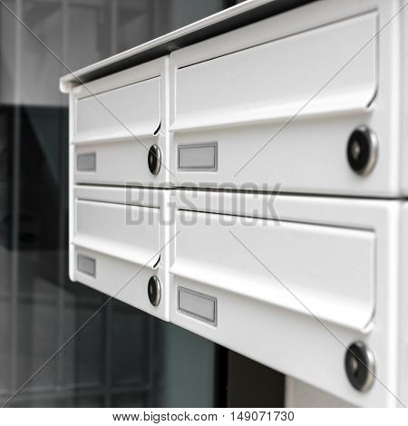 Four modern mailboxes of an apartment building (shallow DOF).