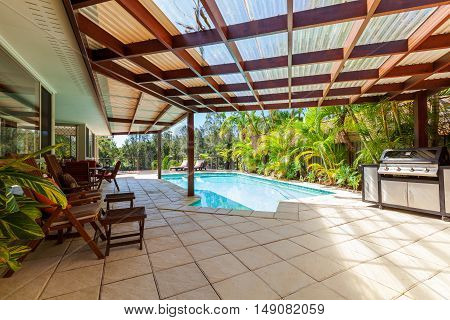Alfresco backyard dining table with smiming pool