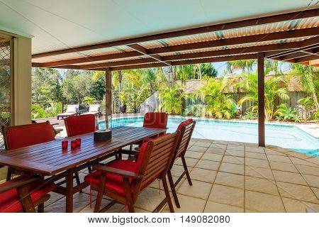 Alfresco backyard dining table with smiming pool