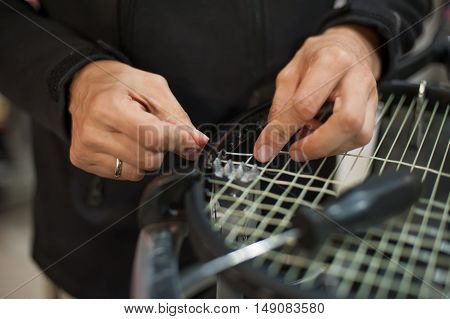 Close Up Of Tennis Stringer Hands Doing Racket Stringing