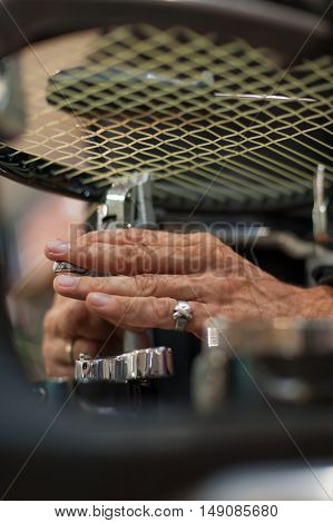 Close Up Of Tennis Stringer Hands Doing Racket Stringing